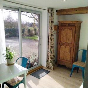 a room with a window and a table and chairs at Studio Nature in Marboz