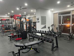 a gym with a bunch of equipment in a room at 221B Baker in Ấp Phú Thọ