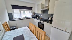 a small kitchen with a table and chairs in it at 7 The Burrows in Braunton