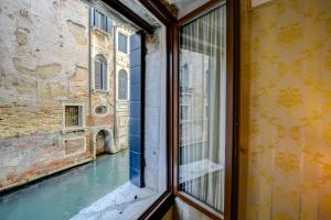 a view from a window of a canal at Locanda La Corte in Venice