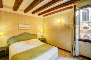 a bedroom with a bed and a window at Locanda La Corte in Venice