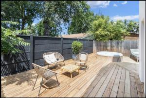 a patio with chairs and a table on a wooden deck at TI KASA et SPA in Andernos-les-Bains +2 photos