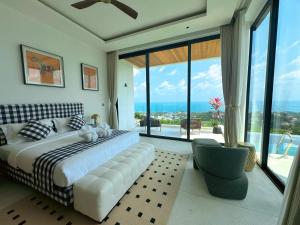a bedroom with a large bed and a large window at Mountain Top Villa in Bophut +70 photos