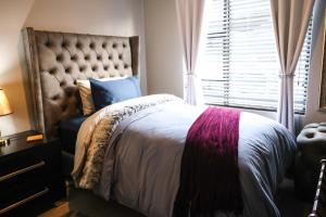 a bedroom with a large bed and a window at Heated Pool Luxury Retreat - 7 Min from OR Tambo in Benoni