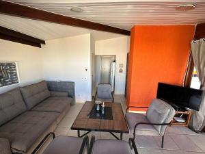 a living room with a couch and a table at Mar e Descanso in Guarapari