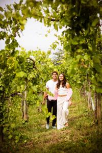 a man and a woman walking through a vineyard at SCHILCHERLANDLEBEN - Weingartenhaus in Sankt Stefan ob Stainz