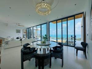 a living room with a glass table and chairs at Mountain Top Villa in Bophut
