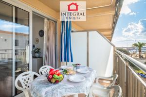 a table on a balcony with a bowl of fruit at Why Not Apartment Palamós in Palamós +16 photos