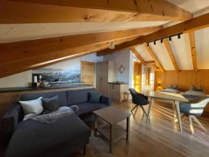 a living room with a blue couch and a table at Landhaus Elisabeth in Krün