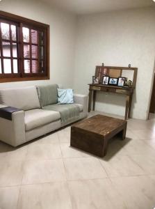 a living room with a couch and a coffee table at Rick estadia in São Gabriel