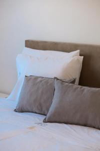 a bed with four pillows on top of it at Casa Cabeça in Macedo de Cavaleiros +7 photos