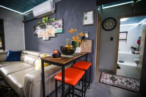 a living room with a couch and a table at Heated Pool Luxury Retreat - 7 Min from OR Tambo in Benoni