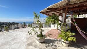 a patio with potted plants on top of a building at Casa Aca in Acapulco