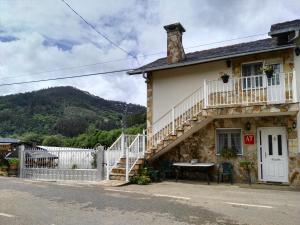 a house with a staircase and a table outside at Apartamentos Casa Alvarina - Luarca in Cortina