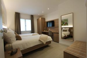 a hotel room with a bed and a mirror at LA MUELE Affittacamere in Gemona del Friuli +31 photos