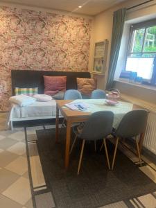 a living room with a table and chairs and a couch at Ferienwohnung Rhöner Luft in Bad Brückenau
