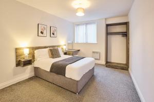 a bedroom with a large bed and a window at Host & Stay - Promenade Suite in Blackpool