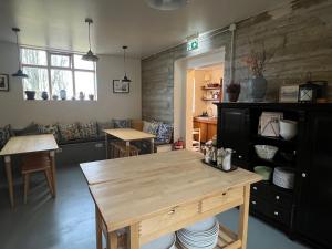 a kitchen with a wooden table and a dining room at Skyrhusid Guesthouse in Hali