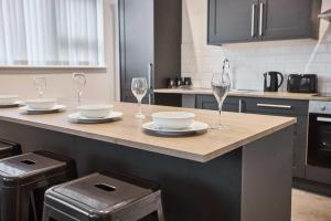 a kitchen with a counter with wine glasses on it at Host & Stay - Promenade Suite in Blackpool