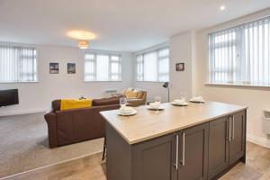 a living room with a couch and a table at Host & Stay - Promenade Suite in Blackpool
