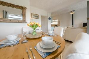 a dining room table with a vase of flowers on it at 2 Bed in Bishopston oc-h28996 in Bishopston