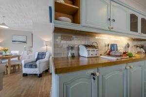 a kitchen with white cabinets and a counter top at 2 Bed in Bishopston oc-h28996 in Bishopston +14 photos