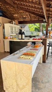 a table with food on it in a kitchen at Recanto da Mari in Paraty