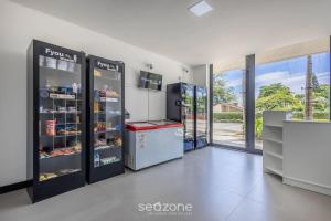 a gas station with two refrigerators in a room at Studios in a seaside building, close to Beto Carreiro at Penha Spot - PSOB in Gravata