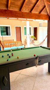 a pool table with balls on it in a patio at Recanto da Mari in Paraty