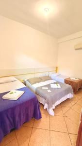 a hospital room with two beds with towels on them at Recanto da Mari in Paraty +31 photos