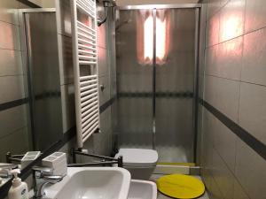 a bathroom with a toilet and a sink and a mirror at Appartamento Annurca in Naples +26 photos