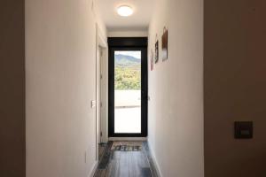 a hallway with a window with a view of a mountain at Comeback el Rinconcito de Guajar in Guájar-Faragüit