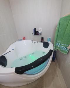a bath tub with a surfboard on it in a bathroom at La Mer Villa - Entire Cottage in Plomari
