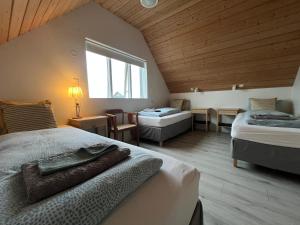 a large room with two beds and a window at Skyrhusid Guesthouse in Hali