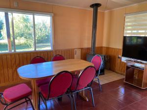a dining room with a table and chairs and a fireplace at Patagonia Bordelago Lodge in Puerto Ingeniero Ibáñez