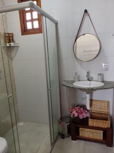 a bathroom with a sink and a mirror at Bella Casa Bougainville - APA Barra de Mamanguape in Rio Tinto