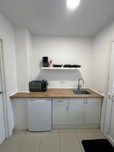 a kitchen with a sink and a counter top at Apartamento cerca de la playa 8 in Vigo +4 photos