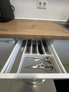 a drawer with scissors and other utensils in it at Apartamento cerca de la playa 8 in Vigo