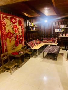 a room with benches and tables in a store at Km 0 home Du Già in Muong Cha