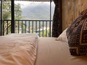 a bed in a room with a view of a mountain at Km 0 home Du Già in Muong Cha +49 photos