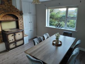 a dining room with a table and a brick oven at GiGi's Bungalow in Galway