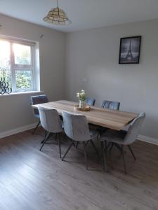 a dining room with a wooden table and chairs at GiGi's Bungalow in Galway
