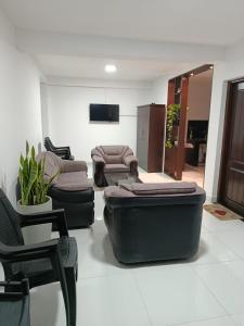 a living room with couches and chairs and a tv at Magnola Hotels in Bandarawela