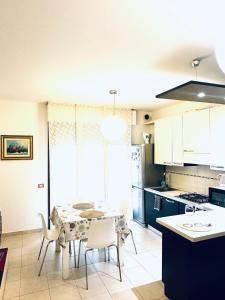 a kitchen and dining room with a table and chairs at Appartamento Carino Splendido Trivano Panoramico IUN S3308 in Quartucciu