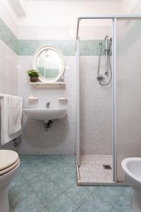 a bathroom with a shower and a sink and a toilet at Hotel Solaris in Gatteo a Mare