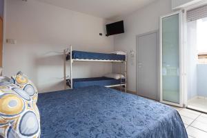 a bedroom with a bed and a bunk bed at Hotel Solaris in Gatteo a Mare +5 photos