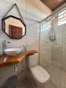 a bathroom with a sink and a toilet and a shower at Bella Casa Ipê 1º andar APA Barra de Mamanguape in Rio Tinto +39 photos