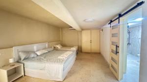 a small bedroom with two beds and a shower at Amaro Villas 1246 Barbados 231 Feel like when you're home 1839 in Saint Thomas +15 photos