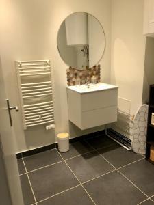 a bathroom with a sink and a mirror at Au Passe-Temps in Mettray