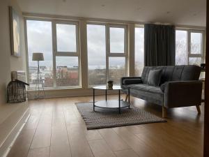 a living room with a couch and a table at Newcastle City Penthouse in Newcastle upon Tyne